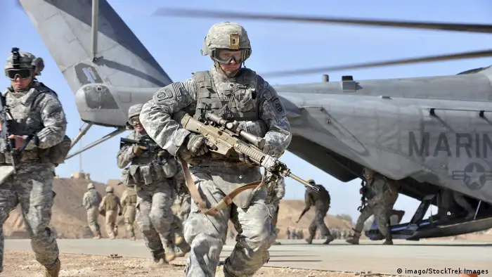 A U.S. Army soldier runs over to provide security after unloading from a CH-53 Sea Stallion helicopter