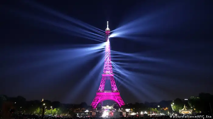 A light show illuminates the Eiffel Tower for its 130 year anniversary
