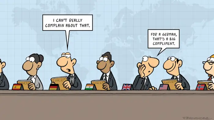Fernandez cartoon: an international assembly with a German commenting on a concept