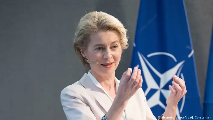 Ursula von der Leyen in front of NATO flag
