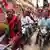 A group of people on motorbikes take part in a rally in the city of Varanasi