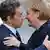 French President Nicolas Sarkozy and German Chancellor Angela Merkel greet one another