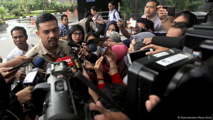 A man answers questions of journalists