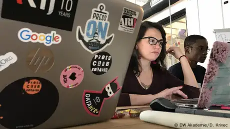 journalists work in front of their laptops