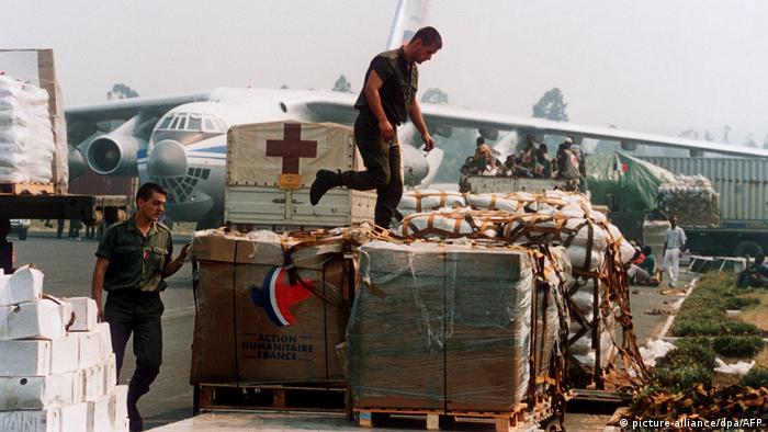 Two French soldiers examine aid boxes for refugees at the airstrip in Goma (1994)