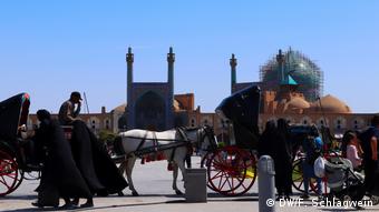 Horse-drawn carriages on Imam Square in Isfahan, Iran
