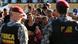 Security forces stand guard as angry relatives gather outside a prison complex in Brazil after hearing about the deaths of inmates (REUTERS/Bruno Kelly) Security forces stand guard as angry relatives gather outside a prison complex in Brazil after hearing about the deaths of inmates (REUTERS/Bruno Kelly)