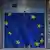 The flag of the European Union adorns the sliding entry doors into the European Commission building in Brussels