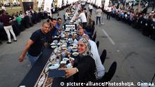 (190601) -- NEW ADMINISTRATIVE CAPITAL (EGYPT), June 1, 2019 () -- A woman takes selfies during a mass iftar, the meal to end their fast at sunset, in Egypt's New Administrative Capital, about 50 kilometers east of Cairo, on June 1, 2019. (/Ahmed Gomaa) |