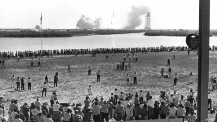 Reporters huddled in the Kennedy Space Center press area to follow the launch of Apollo 11