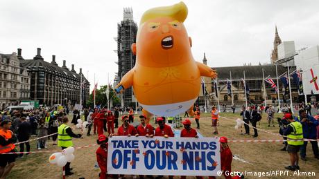 Anti-Trump demonstrators pose in front of a giant balloon depicting US President Donald Trump as a baby (Getty Images/AFP/T. Akmen)