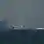 An Emirati coast guard vessel passes an oil tanker off the coast of Fujairah, United Arab Emirates