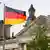 German flags wave in the breeze in front of the parliament building in Berlin