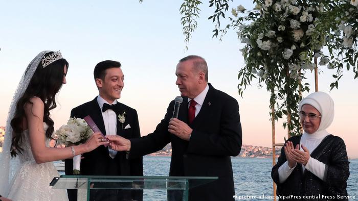Mesut Özil at his wedding alongside his bride and Erdogan