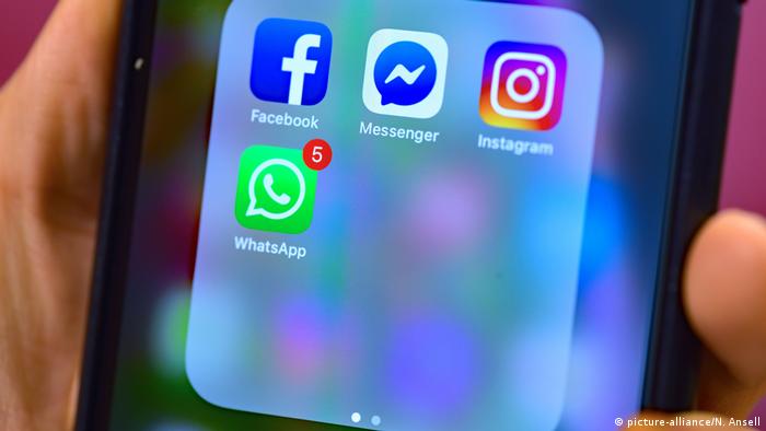 The app logos for Facebook, Facebook Messenger, Instagram, and WhatsApp displayed on the screen of a mobile phone