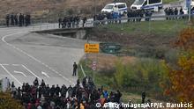 24.10.2018 +++ Asian migrants face mixed Bosnian and Croatian police road block during an illegal crossing attempt, at Maljevac border crossing with neighboring Croatia, near Northern-Bosnian town of Velika Kladusa, on October 23, 2018. - In their struggle with large number of in coming migrants, Bosnian authorities have provided two additional capacities, in abandoned army barracks in Hadzici and a former appliance factory in Bihac. Regardless of the authority's efforts, groups of migrants chose to leave Bosnia and attempt an illegal crossing into neighboring Croatia, hoping to travel further into the EU countries. (Photo by ELVIS BARUKCIC / AFP) (Photo credit should read ELVIS BARUKCIC/AFP/Getty Images)