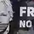 A poster of Julian Assange with an american flag on his mouth