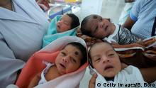 Indian nurses care for newly born babies at the maternity ward of a hospital on the eve of World Population Day, in Guwahati on July 10, 2014. World Population Day, which was established by the United Nations Development Programme in 1989 and is observed annually, seeks to raise awareness of global population issues. AFP Photo/ Biju BORO (Photo credit should read BIJU BORO/AFP/Getty Images)