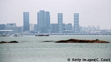 KINMEN COUNTY, TAIWAN - APRIL 20: The Chinese city of Xamen is seen from the Taiwanese island of Little Kinmen which, at points lies only a few miles from China, on April 20, 2018 in Kinmen, Taiwan. China recently carried out live-fire military drills in the Taiwan Strait involving its Liaoning aircraft carrier, an exercise interpreted as a show of force and a message to self-governed Taiwan which China claims as its territory. The naval exercise was the first in the Taiwan Strait since 2016 and was held just over 100 miles off the coast of Taiwan. Following the defeat of the ruling Kuomintang party by the Chinese Communist Party and their retreat to Taiwan in 1949, cross-strait relations have varied from open conflict to diplomatic war. China's President, Xi Jinping, recently emphasised China's sovereignty over Taiwan by stating that 'We have sufficient abilities to thwart any form of Taiwan independence attempts'. Beijing has also imposed financial restrictions by significantly limiting the number of Chinese tour groups allowed to visit Taiwan and imposed trade sanctions on the island. (Photo by Carl Court/Getty Images)