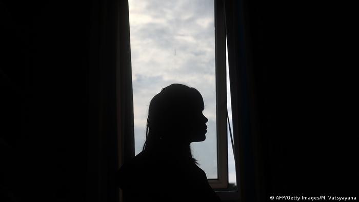 A Vietnamese woman who was rescued from a brothel in China sits near a window