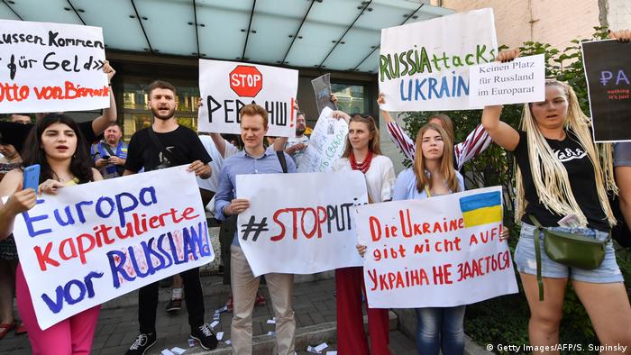 Ukrainians protesting in front of the German embassy in Kyiv over Russia's restored voting rights in the Council of Europe