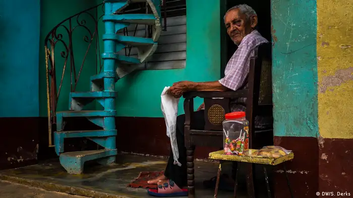 A man sitting in front of his house in Cuba