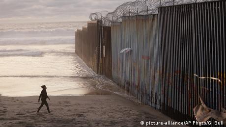 A large wall goes into the Pacific Ocean at the beaches of San Diego and Tijuana.