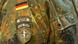 A Bundeswehr uniform shows the NATO KFOR mission patch underneath the German tri-color flag A Bundeswehr uniform shows the NATO KFOR mission patch underneath the German tri-color flag