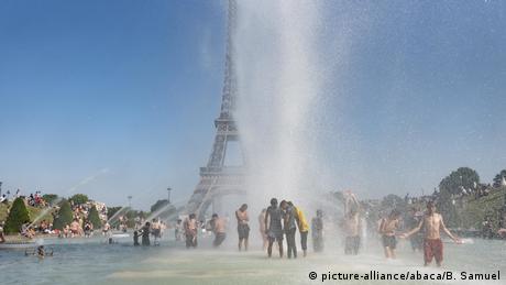 People cool off in a Paris fountain during the 2019 heatwave