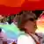 Woman holds up a rainbow flag at Skopje Pride Parade