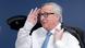 Jean-Claude Juncker with right hand raised in a seeming salute Jean-Claude Juncker with right hand raised in a seeming salute