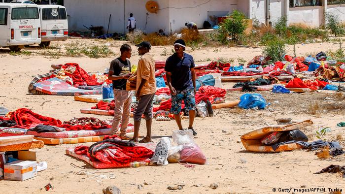 Libyan migrants outside a detention center near Tripoli after a deadly airstrike