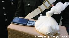 Naples, ITALY: Italian carabinieri shows 800g of cocaine after Italian Police conduct a raid in the southern Italian city of Naples, 12 december 2006. Naples police arrested more than 60 people across the country, suspected of criminal association linked to international drug trafficking.the investigations are the result of colaboration with the judicial and Police authorities of Spain, of France, of Germany, of Ecuador and of Colombia. AFP PHOTO / MARIO LAPORTA (Photo credit should read MARIO LAPORTA/AFP/Getty Images)