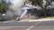 A firefighter aims a hose at a burning house following the earthquake A firefighter aims a hose at a burning house following the earthquake
