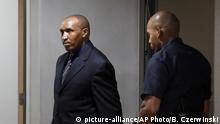 Bosco Ntaganda, a Congo militia leader, left, enters the courtroom of the International Criminal Court (ICC) for the closing statements of his trial in The Hague, Netherlands, Tuesday Aug. 28, 2018. Ntaganda is facing charges of war crimes and crimes against humanity allegedly committed in the eastern Ituri region of Congo from 2002-2003. (Bas Czerwinski/Pool via AP) |