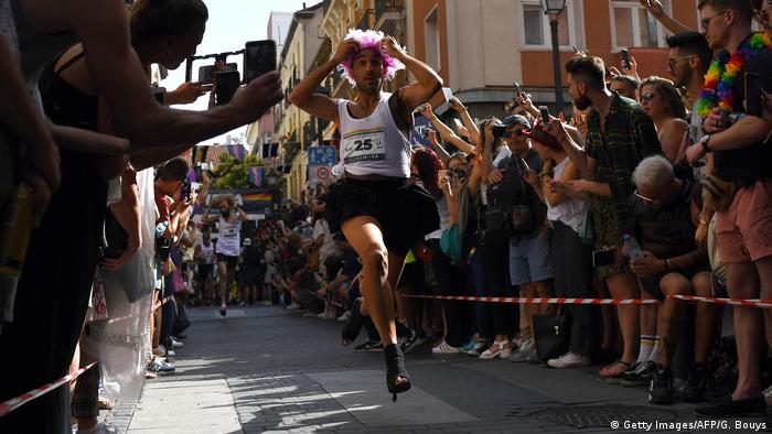 A participant runs during a high-heel race as part of Gay Pride month in the neighbourhood of Chueca in Madrid (Getty Images/AFP/G. Bouys)