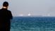 A man looks out at the Gulf of Oman A man looks out at the Gulf of Oman