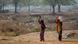 Two women walking with water containers in dry Indian landscape Two women walking with water containers in dry Indian landscape