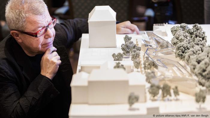 Der US-Stararchitekt Daniel Libeskind sitzt andächtig vor dem Model seines Amsterdamer Momorials.