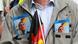 A man carries flyers showing the face of AfD state leader Björn Höcke A man carries flyers showing the face of AfD state leader Björn Höcke