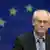 Herman van Rompuy against the backdrop of a European flag