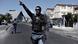 Armed South African police officer patrol in a street as they respond to a shooting of alleged gang members in Manenberg, a Cape Town suburb Armed South African police officer patrol in a street as they respond to a shooting of alleged gang members in Manenberg, a Cape Town suburb