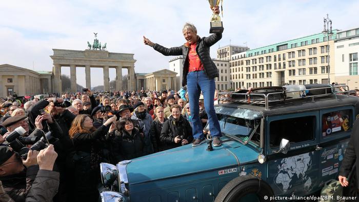 Heidi Hetzer returning from her circumnavigation of the world in front of the Brandenburg Gate, Berlin.