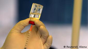 Νοσηλευτής προετοιμάζεται να χορηγήσει το εμβόλιο κατά του ιού Έμπολα.