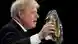 Boris Johnson holding up a bagged smoked fish