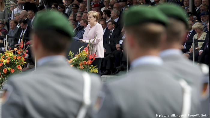 German Chancellor Angela Merkel, center, delivers a speech during an oath-taking ceremony of the German army at the Defence Ministry in Berlin, Germany