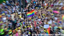 TOPSHOT - Picture taken with zoom effect shows a rainbow flag as participants of the Christopher Street Day gay pride parade walk through the streets of Berlin on July 28, 2018. (Photo by Tobias SCHWARZ / AFP) (Photo credit should read TOBIAS SCHWARZ/AFP/Getty Images)