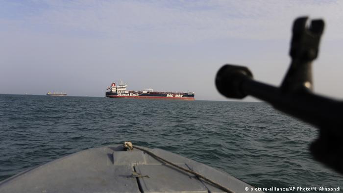 A speedboat of Iran's Revolutionary Guard trains a weapon toward the British-flagged oil tanker Stena Impero