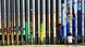 Children stand near the border fence between Mexico and US in Tijuana, Mexico Children stand near the border fence between Mexico and US in Tijuana, Mexico