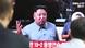 Commuters in Seoul walk past a screen showing an image of Kim Jong Un Commuters in Seoul walk past a screen showing an image of Kim Jong Un